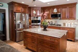 Cherry cabinet kitchen with island and stainless steel appliances
