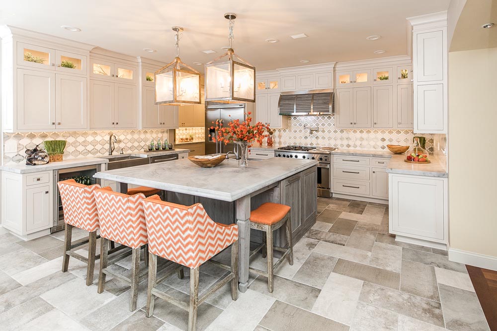 Large gray island paired with white inset cabinets