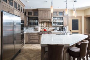 Dark wood tone kitchen with island and pendant lighting
