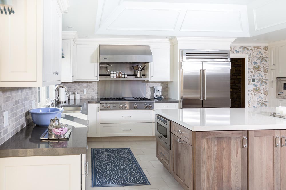 White inset kitchen cabinets with large wood tone island