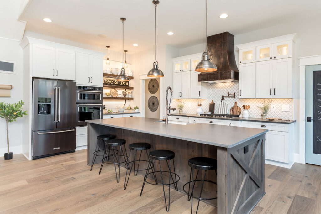 White kitchen cabinets with large grey island from Showplace Cabinetry