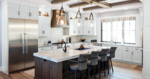 White kitchen cabinets from Showplace Cabinetry with large brown island