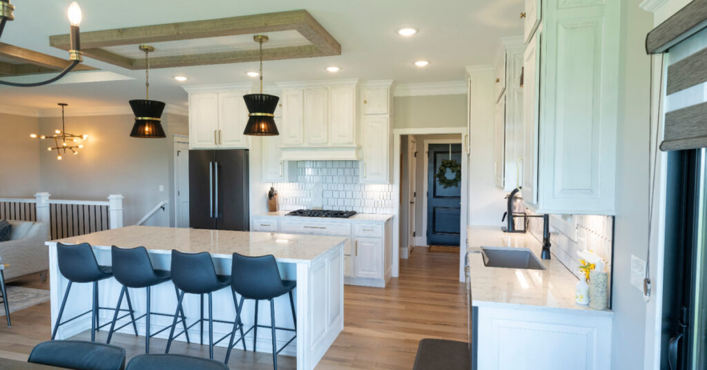 White kitchen framed cabinets with island