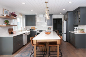 Grey lower and upper cabinets with long woodgrain middle island