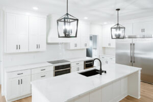 White kitchen cabinetry with large island