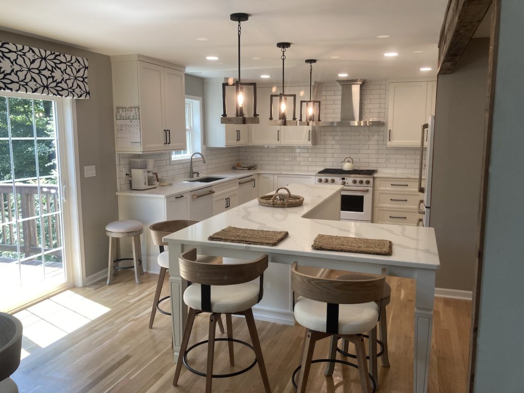 L-shaped kitchen island with seating designed for a long and narrow space in South Abington remodel